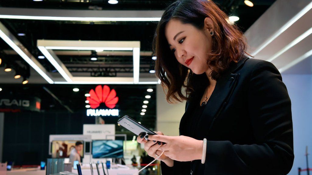 Woman looking at Huawei phone