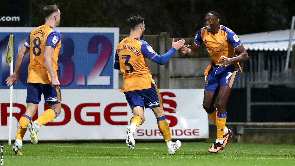 Lucas Akins (right) celebrates his winner for Mansfield against Colchester