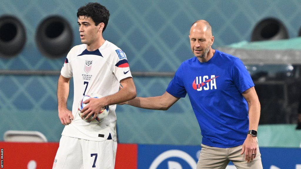 US midfielder Giovanni Reyna (left) receives direction from head coach Gregg Berhalter (right)