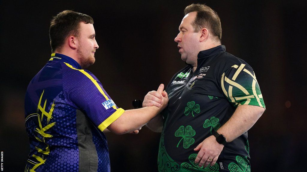 Luke Littler shakes hands with Brendan Dolan after his victory