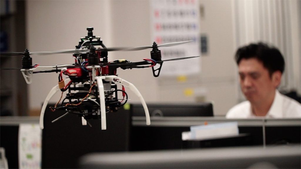 A drone flies in an office in Japan