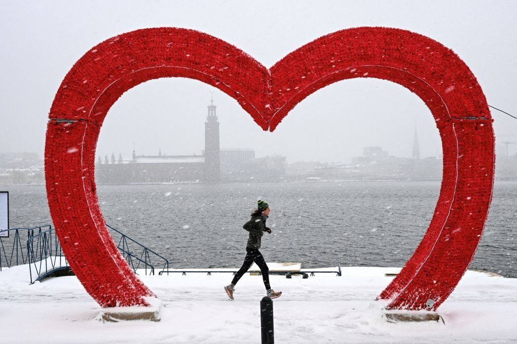 A runner jogs past Stockholm City Hall, Sweden, on 2 January.