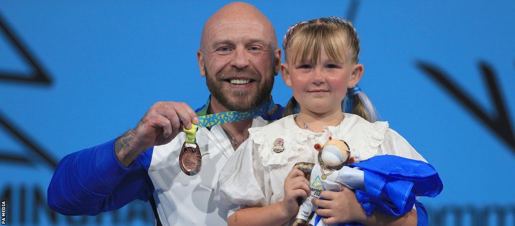 Scotland’s Micky Yule with his Bronze Medal looks on with his daughter Tilly in the Men’s Heavyweight Final at The NEC on day seven of the 2022 Commonwealth Games in Birmingham.