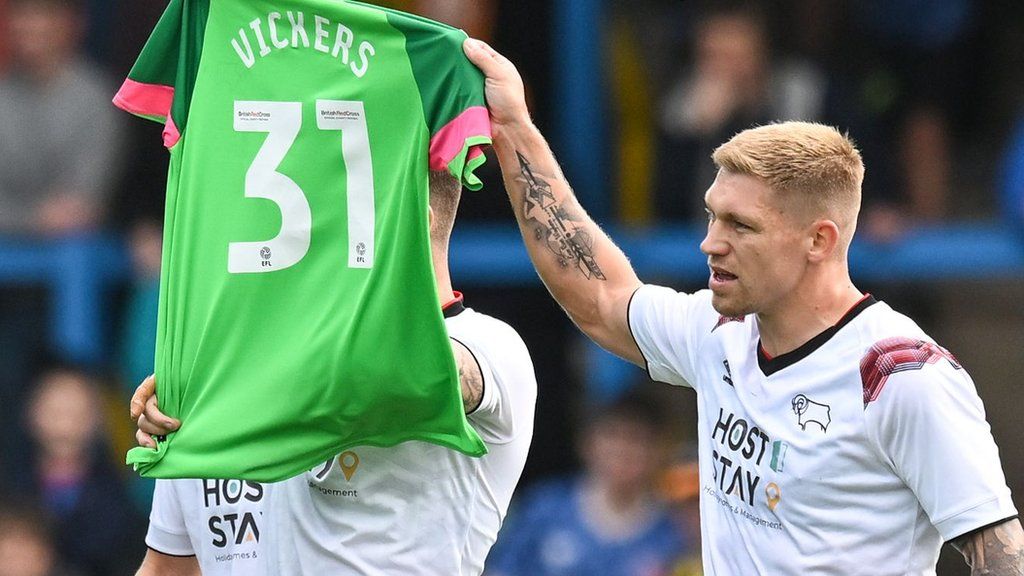 Derby players hold up Josh Vickers' shirt after scoring at Carlisle