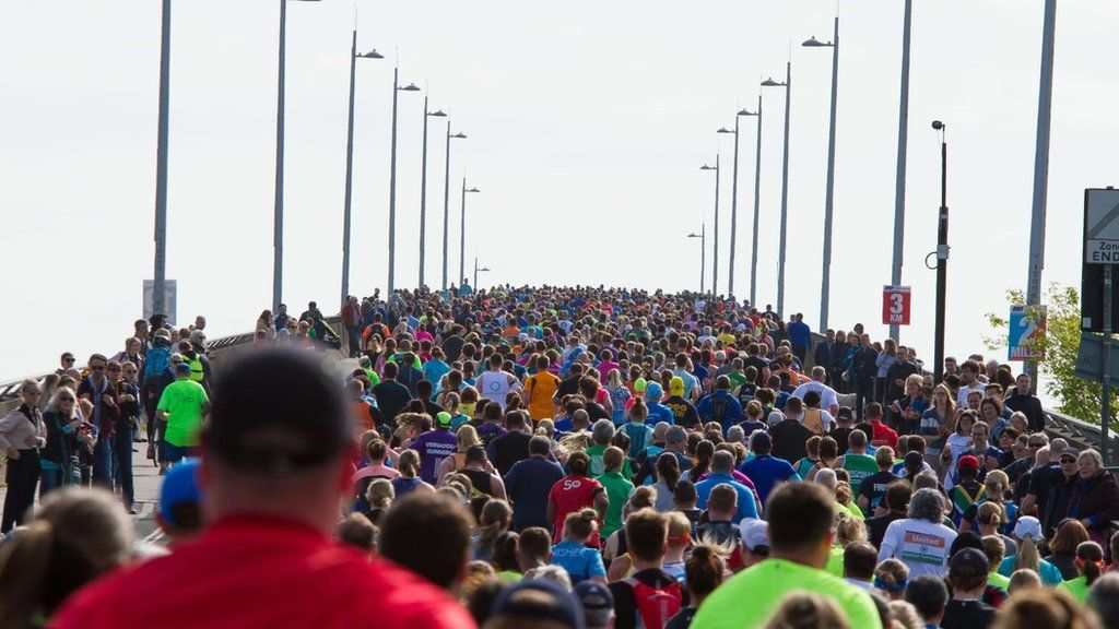 Marathon runners on bridge