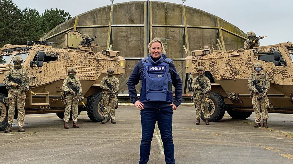 BBC Technology reporter Zoe Kleinman stands in front of military personnel at RAF Honington