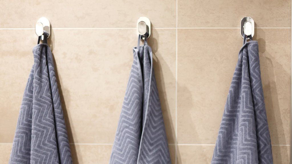 Towels hanging on normal bath hooks (stock image)