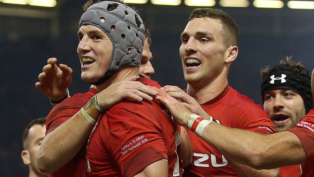 Wales' Jonathan Davies, George North and Leigh Halfpenny celebrate