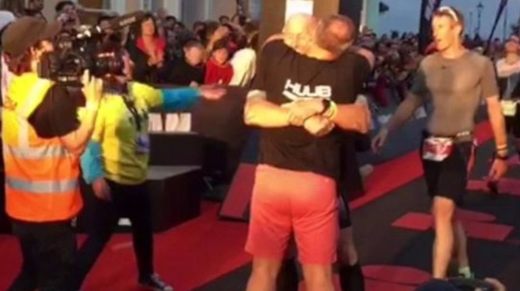 Gareth Thomas is hugged by husband Stephen after finishing the Ironman triathlon in Tenby, Pembrokeshire