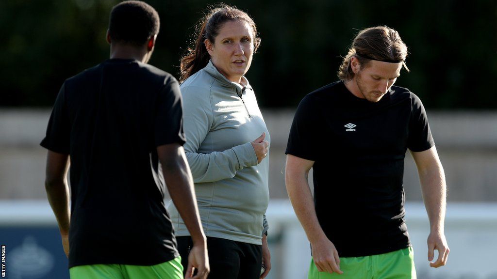 Hannah Dingley speaks with players prior to a pre-season friendly between Melksham Town and Forest Green Rovers in July