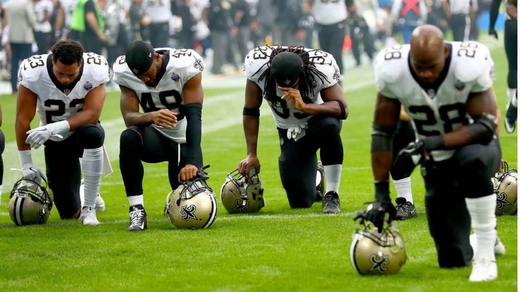 New Orleans Saints players and team kneel prior to the NFL