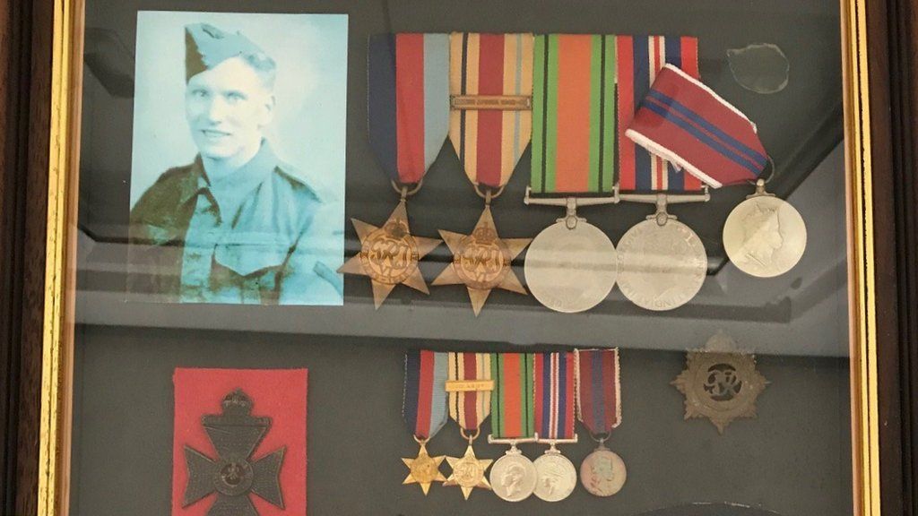 Framed war medals and photographs