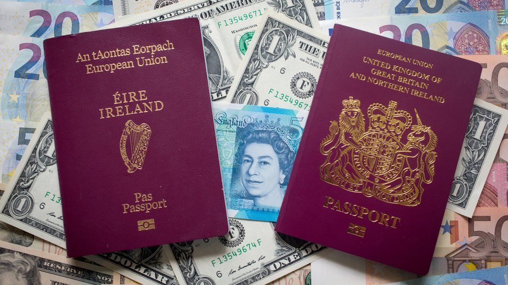 Irish and British passports on top of mixed currency