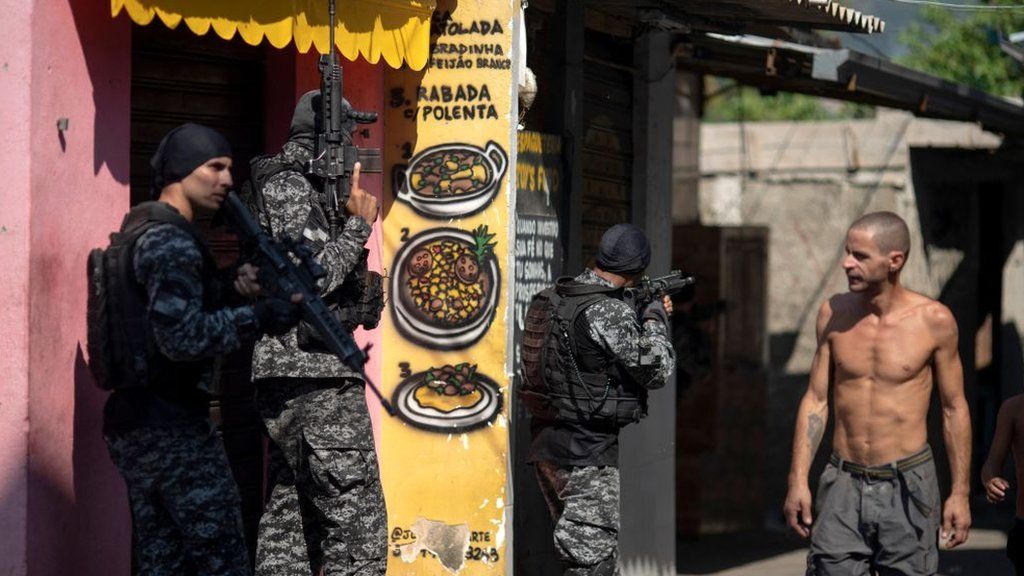 Civil Police officers take part in an operation against alleged drug traffickers at the Jacarezinho favela in Rio de Janeiro