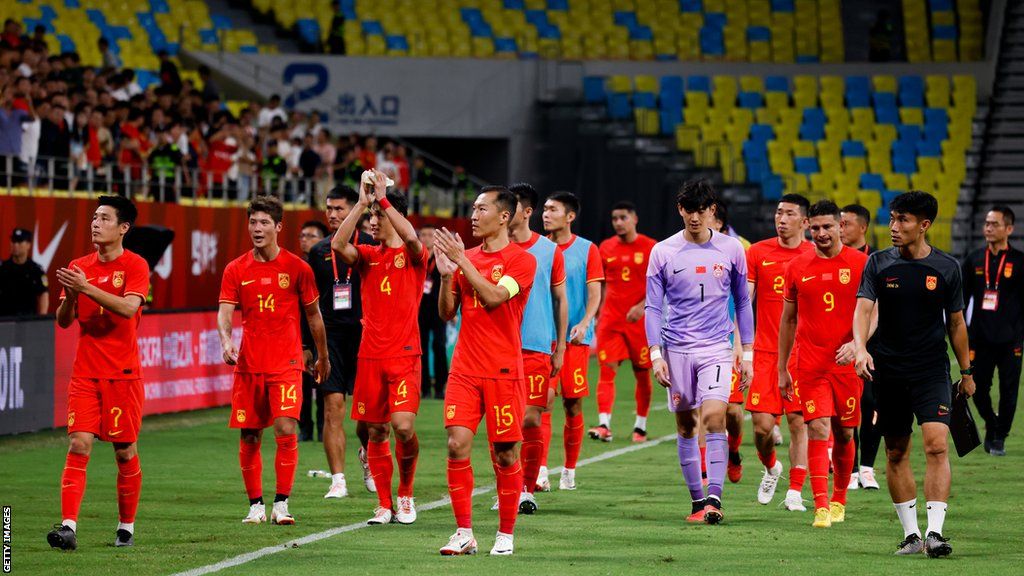Chinese players walk off the pitch after losing 1-0 to Syria