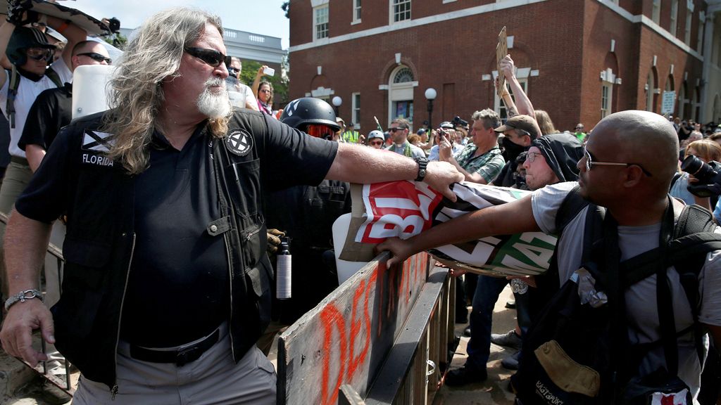 A white supremacist grabs a counter protesters" sign during a rally in Charlottesville, Virginia, U.S.