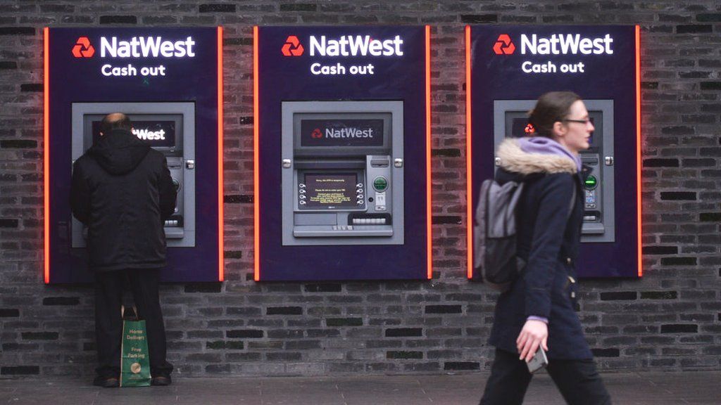 Customers using a NatWest ATM.