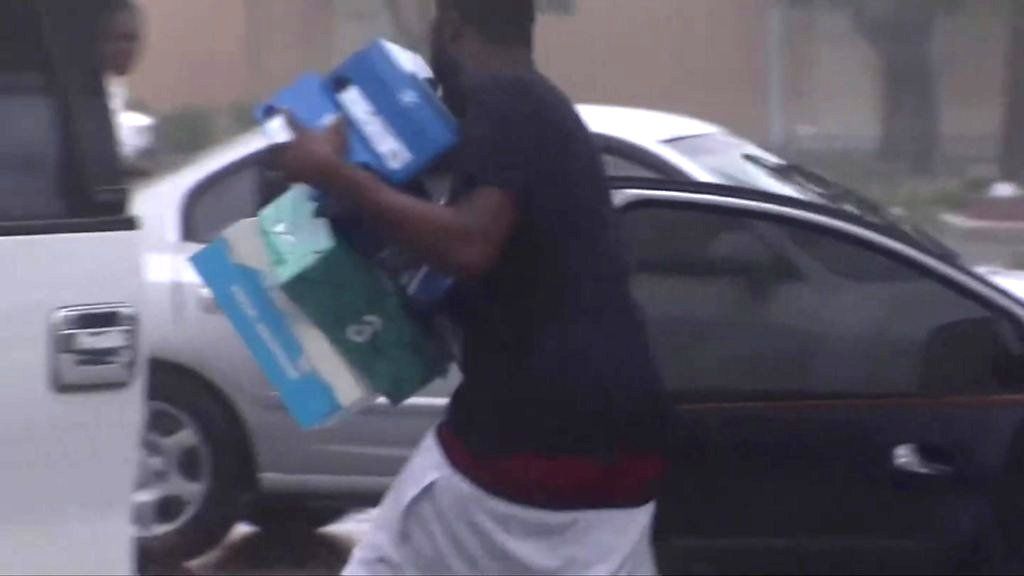 Man runs with shoe boxes