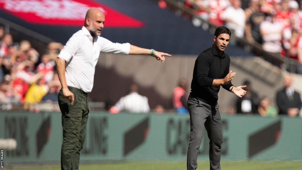 Arsenal boss Mikel Arteta and Man City's Pep Guardiola watch from the sidelines