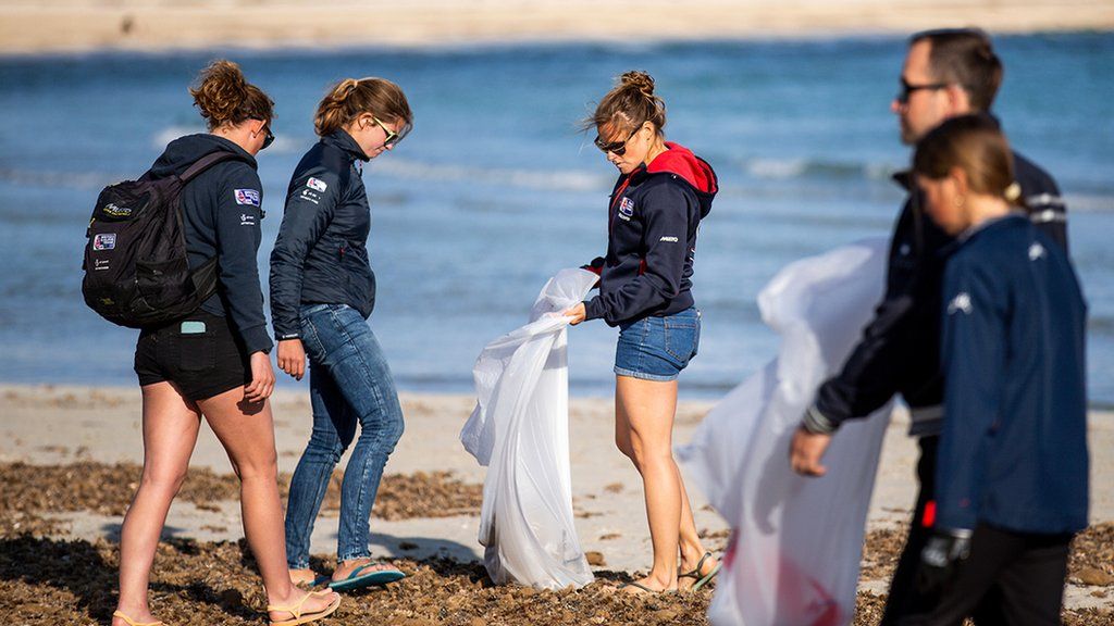 Sailors take part in a beach clean