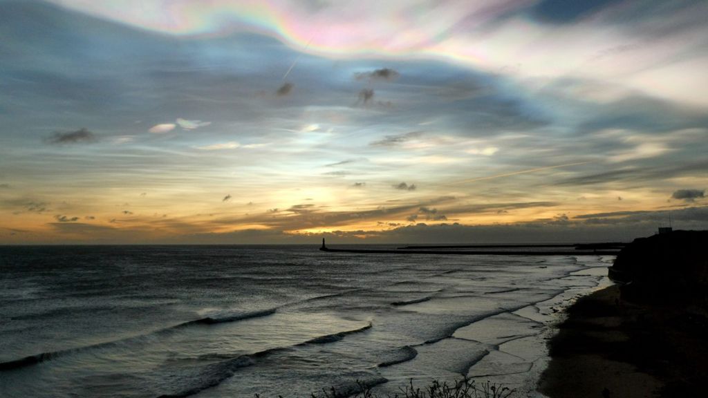 Nacreous clouds at sunrise over the sea