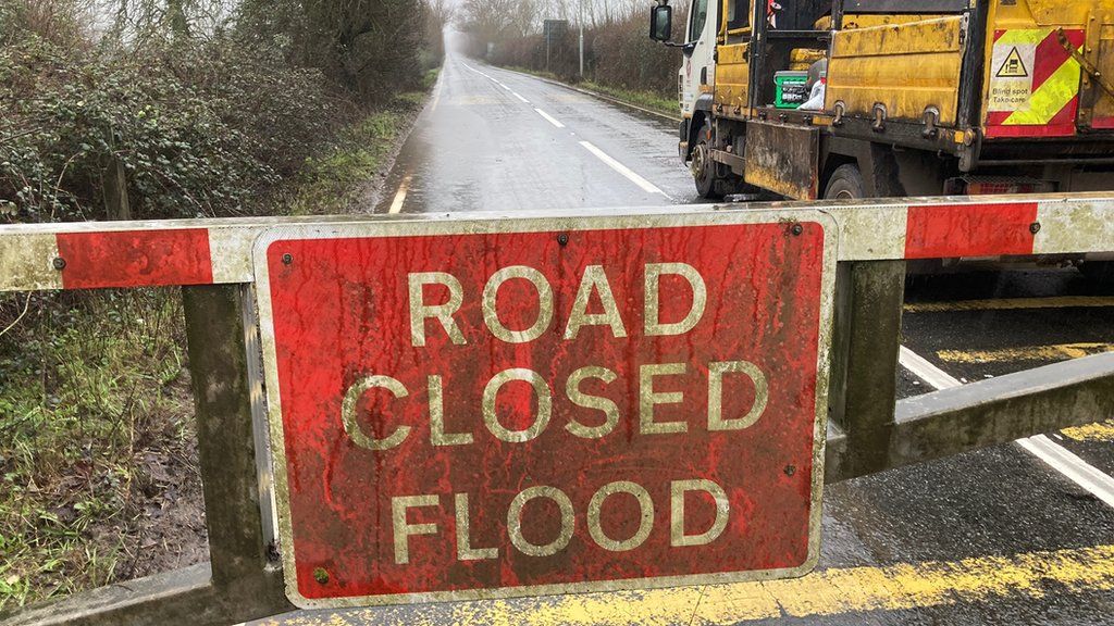 Sign reading "road closed flood"
