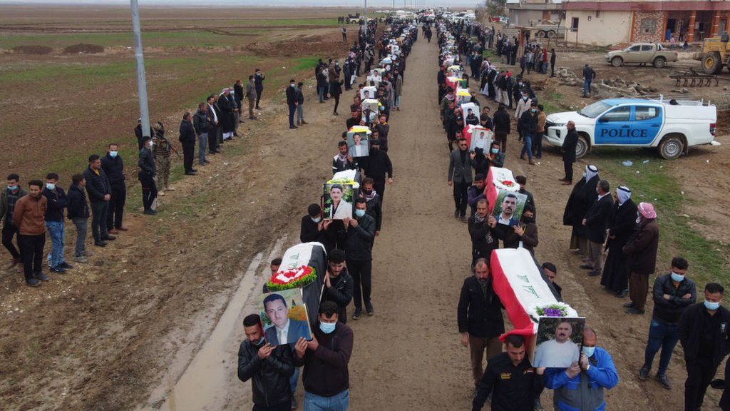 Procession of coffins carried for the mass funeral in Kocho on 6 February 2021