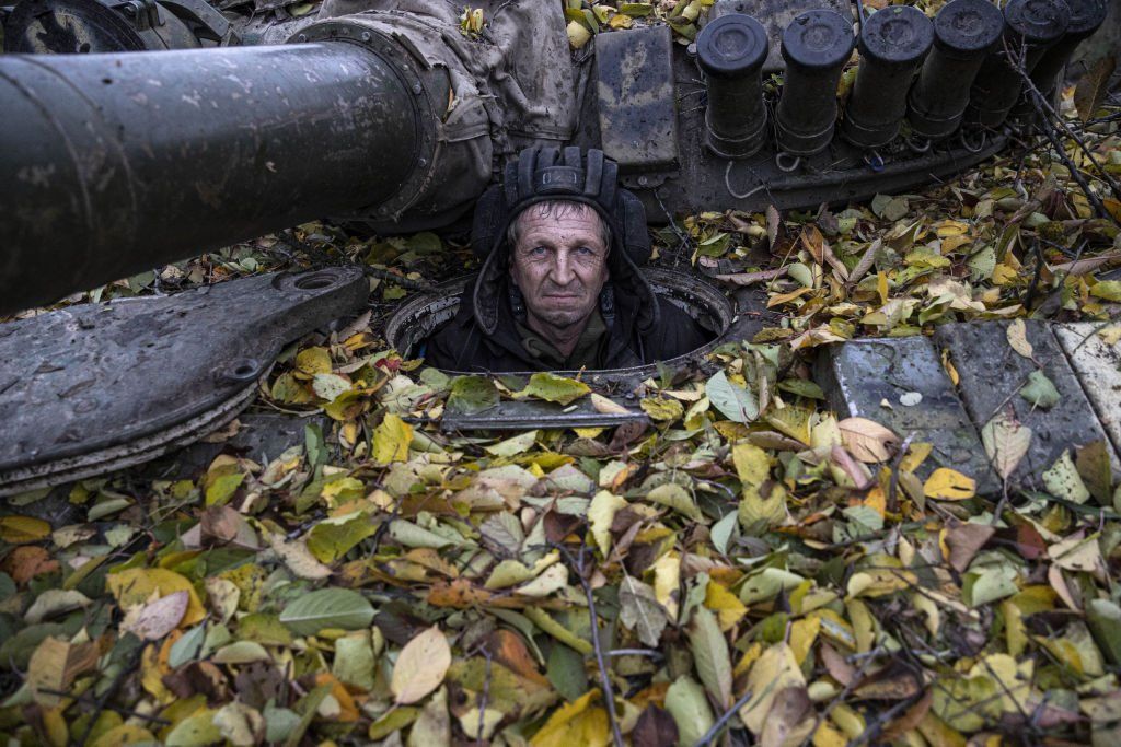 A Ukrainian soldier looks on from a tank
