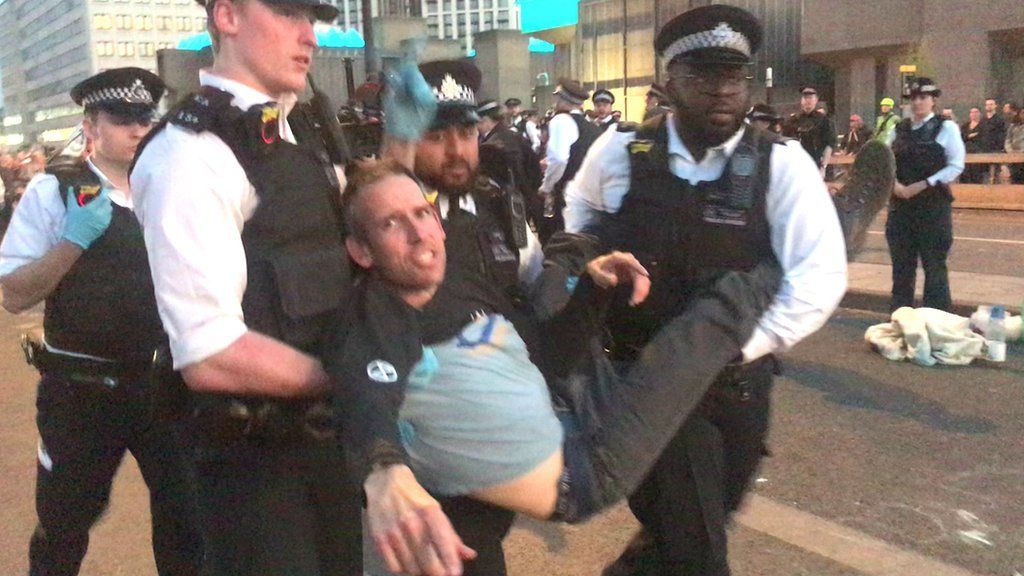 Etienne Stott is carried by police after being arrested