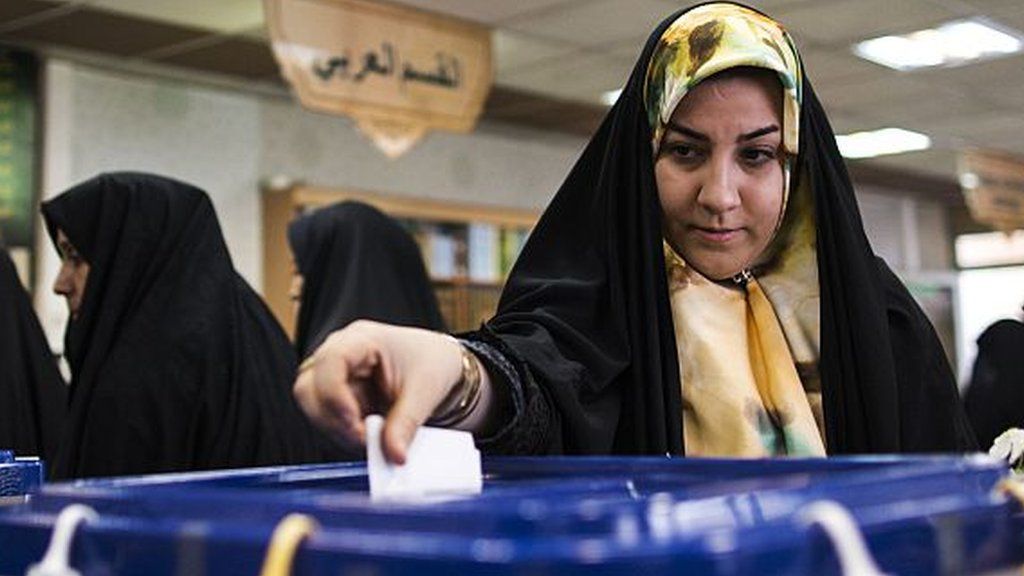 Iranian woman casts vote in Qom (file photo)
