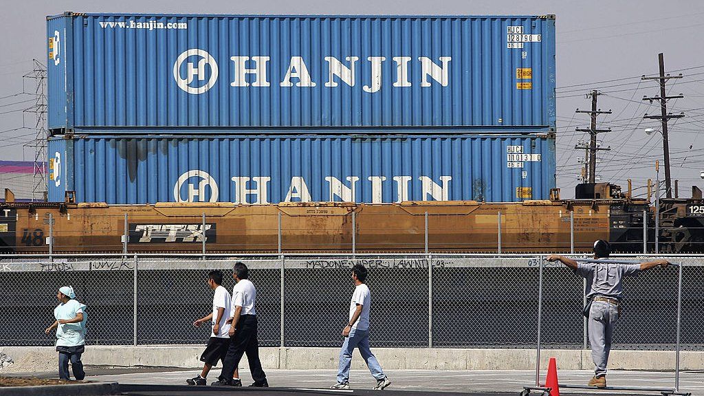 A train carries shipping containers from Hanjin