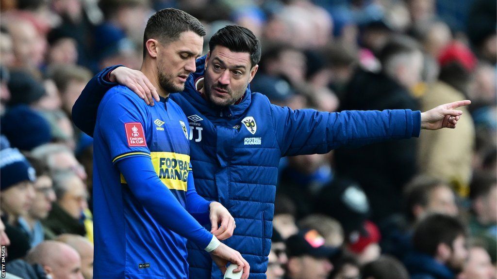 AFC Wimbledon substitute James Ball (left) and his manager Johnnie Jackson