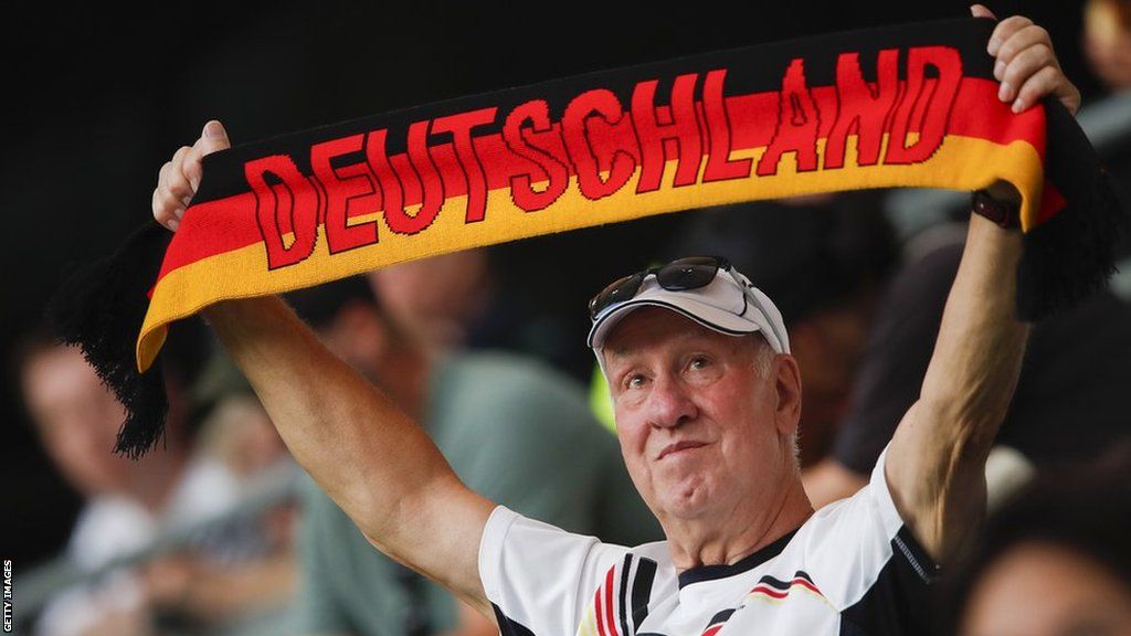 Germany supporter holds up a Deutschland scarf