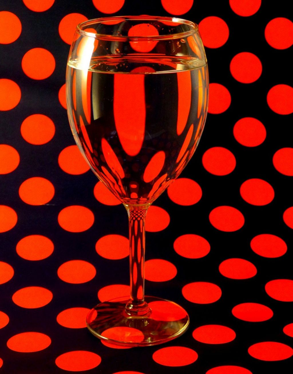 Red circles behind a glass of wine
