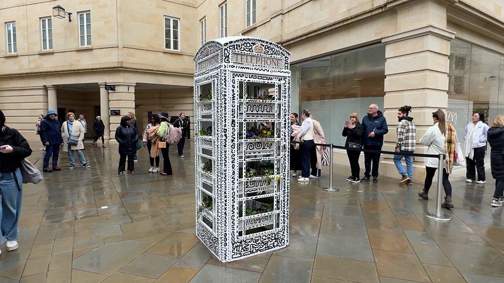 Black and white graffitied telephone box in SouthGate, Bath