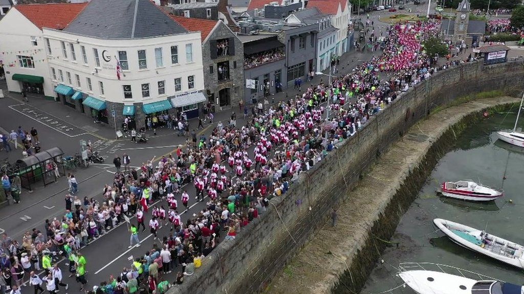 People lining the street in St Peter Port, Guernsey, for The Island Games 2023