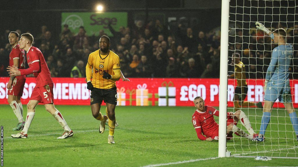 Omar Bogle celebrates after beating Grimsby goalkeeper Harvey Cartwright to score