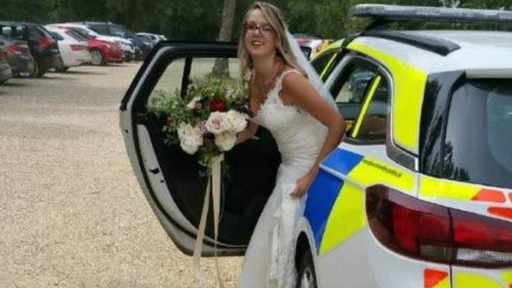 Bride stepping out of police car