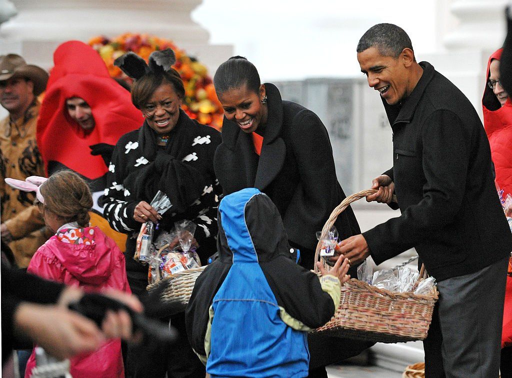 Marian Robinson dressed up and giving children Candy with the Obamas
