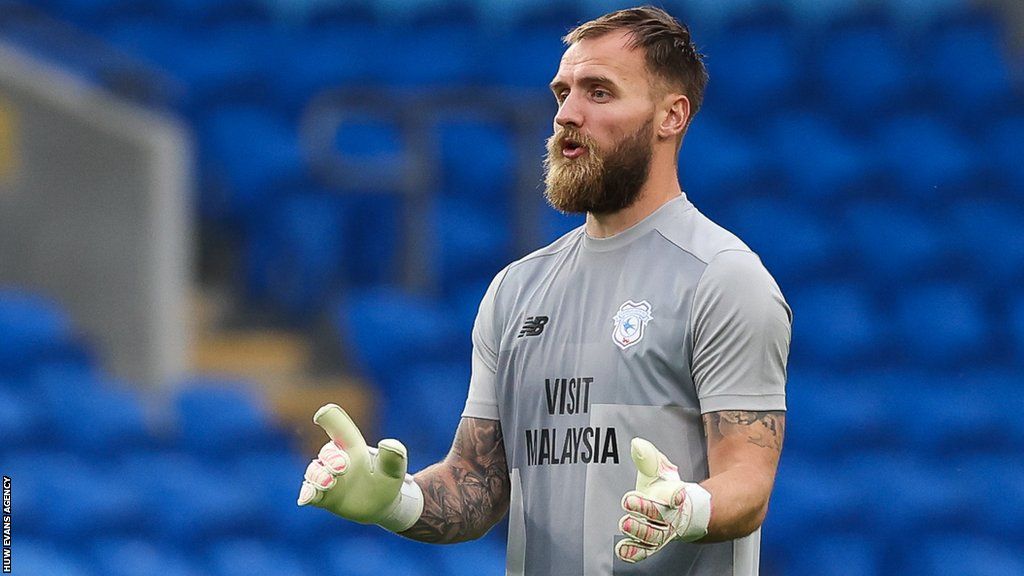 Jak Alnwick warms up with Cardiff City