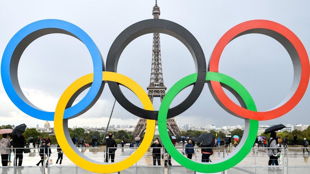 Olympic rings in Paris, with Eiffel Tower in background