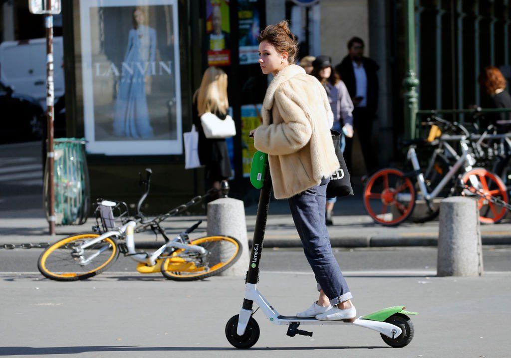 Woman riding e-scooter in Paris