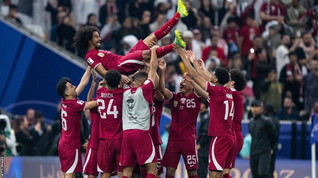 Akram Afif is lifted into the air by his Qatar team-mates following the Asian Cup final at Lusail Stadium