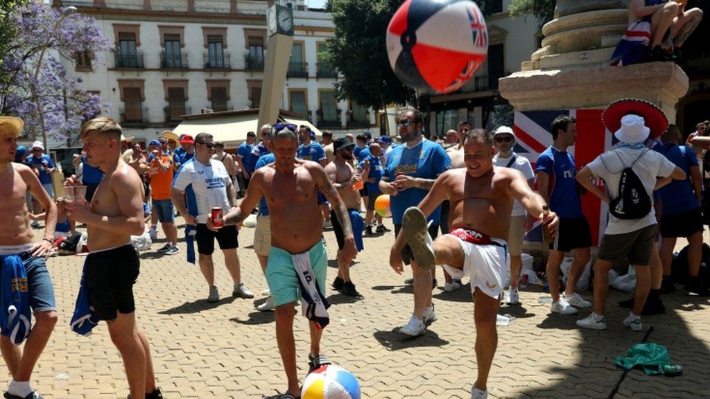 Fans play with a beach ball in Seville