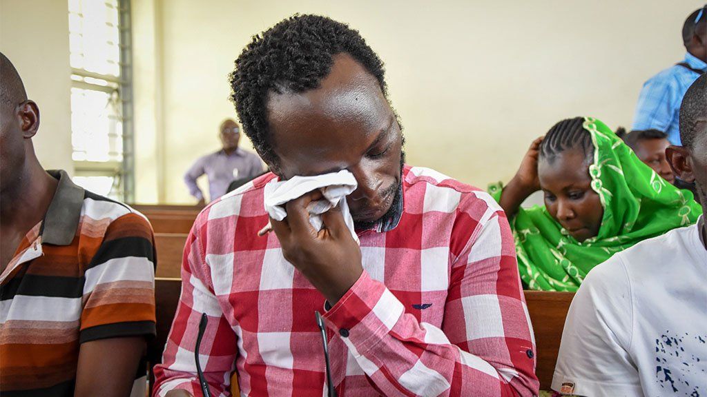Detained Tanzanian journalist Erick Kabendera (C) in court in Dar es Salaam, Tanzania, on 2 January 2, 2020