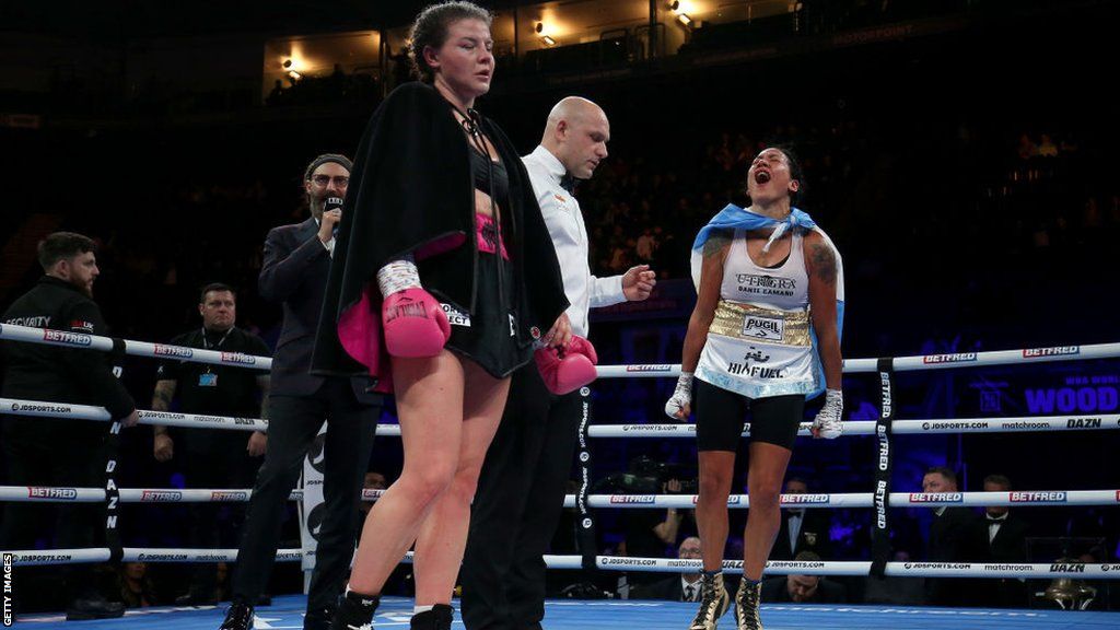 Sandy Ryan reacts as Erica Farias celebrates in the ring