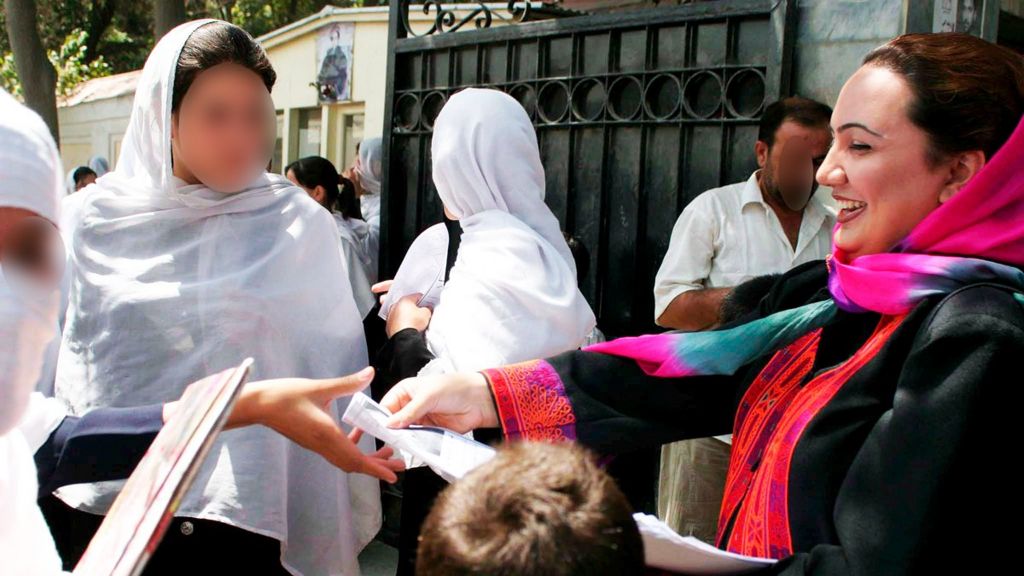 Shukria Barakzai distributing electoral pamphlets to school girls as she campaigns for the parliamentary elections in Kabul, Afghanistan - August 2005