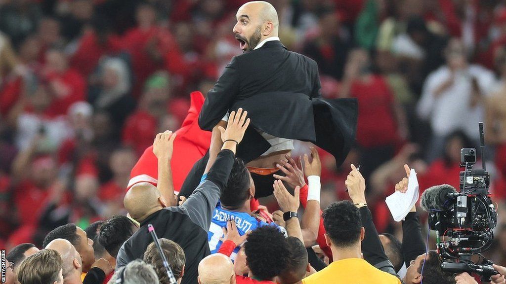 Morocco coach Walid Regragui is thrown into the air after the World Cup quarter-final win over Portugal