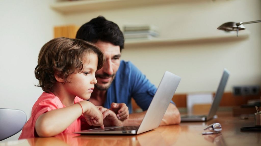 Father and child with laptop