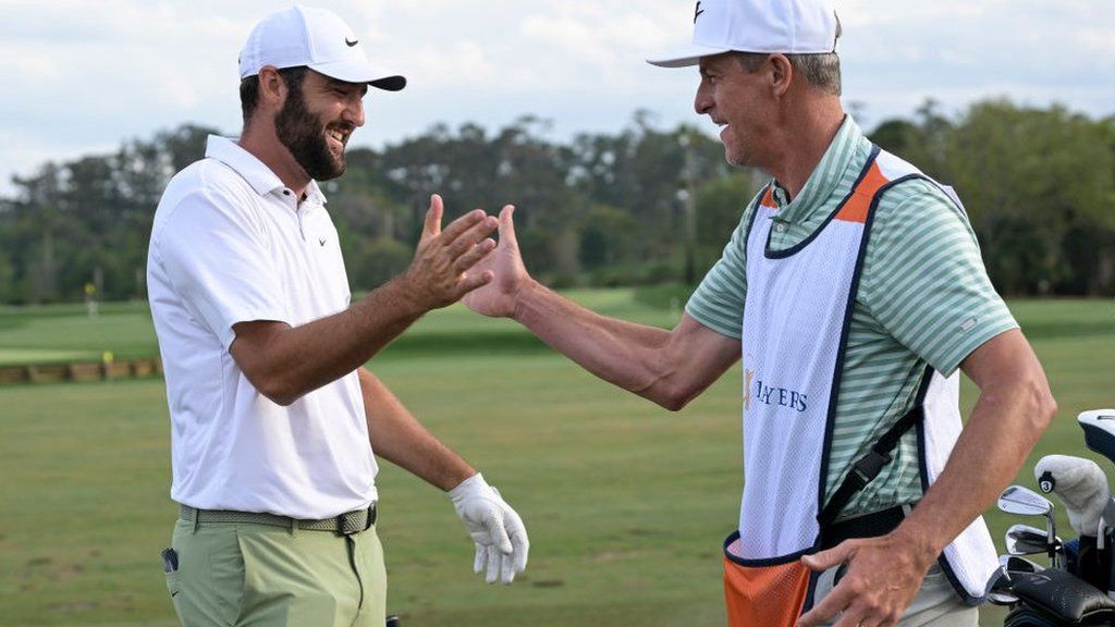 Scottie Scheffler and his caddie Ted Scott celebrate victory at the Players Championship